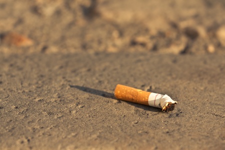 Cigarette fag thrown in the city, horizontal shot with copy spaceの写真素材