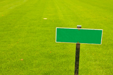 Green grass with a sign, horizontal shot with copy spaceの写真素材