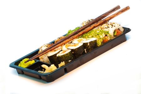 Sushi set with chopsticks in a take away box isolated on whiteの写真素材