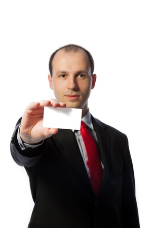 Businessman holding a blank business card, vertical, isolated on whiteの写真素材