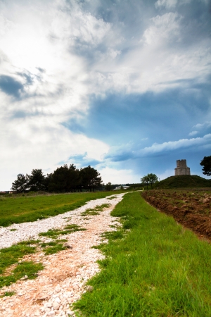 Small church on top of a hill with cloudsの写真素材