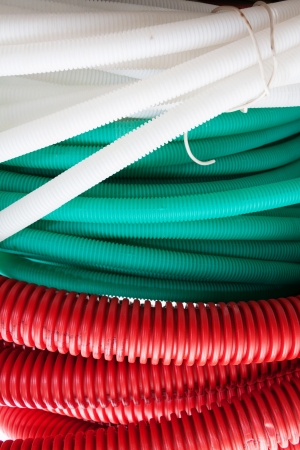 White, green and red cable hosesの写真素材