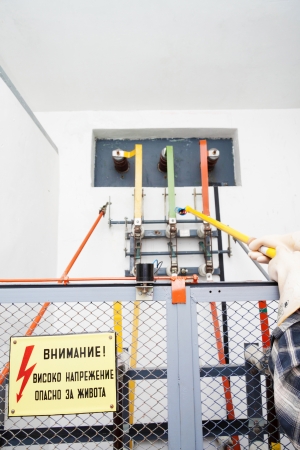Worker with protection gloves checking the status of a high voltage equipementの写真素材