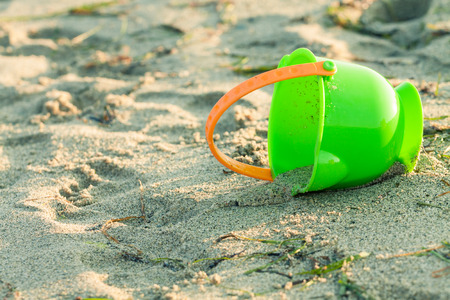 Toy bucket on a beachの写真素材