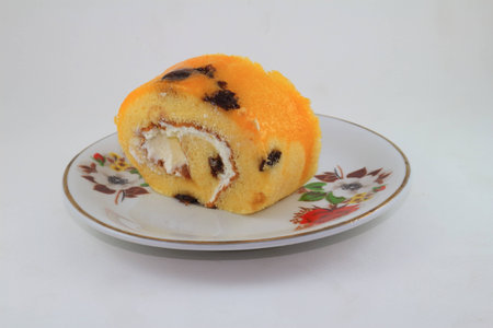 orange Jam roll on the dish with the white backgroundの写真素材