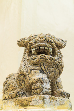 the ancient chinese lion statue under the sun lightの写真素材