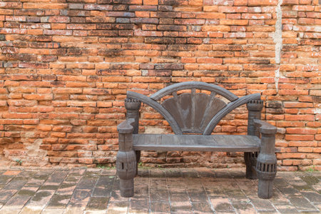 old chair wood with the brick wallの写真素材