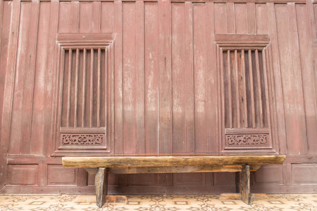 old wood chair with retro wood window backgroundの写真素材