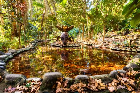 Metal statue of an insect drinking in a pond of the Botanical-Historic Garden La Concepcion in Malaga Spainのeditorial素材