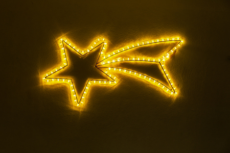 Christmas star made of yellow lightsの写真素材