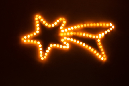 Christmas star made of blurred yellow lightsの写真素材