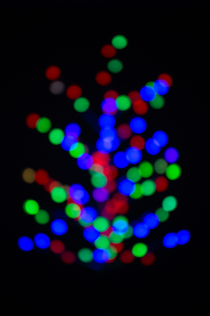 Christmas tree made with blurred colored light bulbs