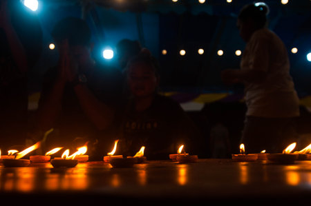 Hindu devotees lighting candles during Diwali festival.