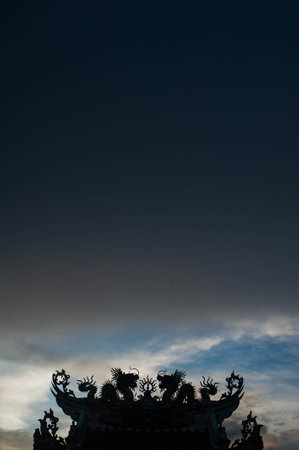 Dragon at the top of the temple in the evening, Thailand.の写真素材