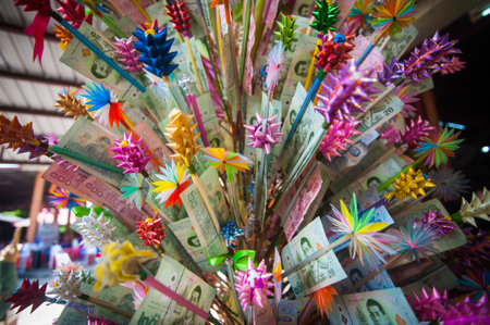 Colorful paper windmill made from dollar banknotes as background.の写真素材