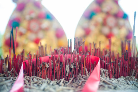 Burning incense sticks in a Chinese temple, closeup of photo