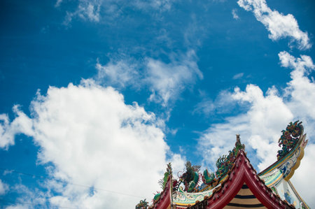 Chinese temple roof with blue sky and white cloud background, Thailand.の写真素材