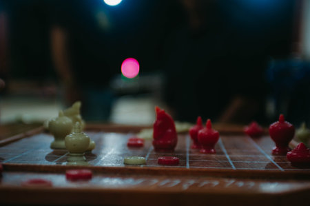 chess board game with red and black figures, shallow depth of fieldの写真素材