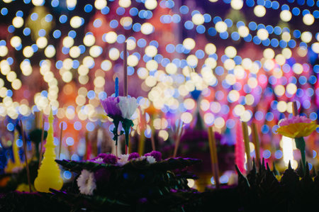 Candle light and flower in temple with bokeh background.の写真素材