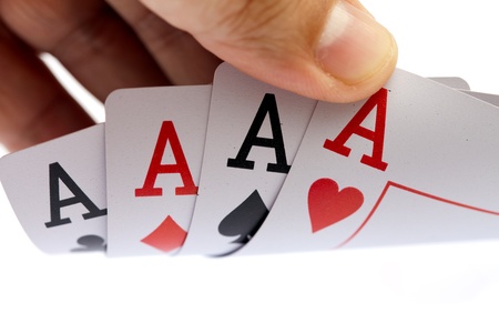 I win. Holding four aces, close up, on white background