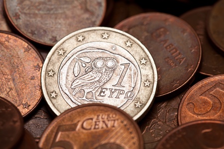 Greek one euro coin among  coins of five cents  (with the owl, ancient symbol of wisdom) の写真素材