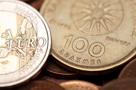 Greek drachmas (hundred) and euro coins (macro shot)の写真素材