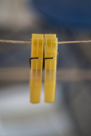 Two yellow Clothes Pins hunging on rope together, Macro shot with vintage lens, Using Shallow depth...