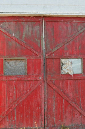 Old doors of abandoned building with broken windowsの写真素材