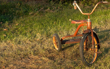 A child's vintage tricycle outside at yard saleの写真素材