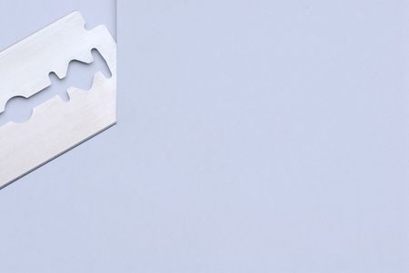 Razor blade is cutting paper with free spaceの写真素材