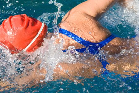 Athletic swimmer in action in a swimming poolの写真素材