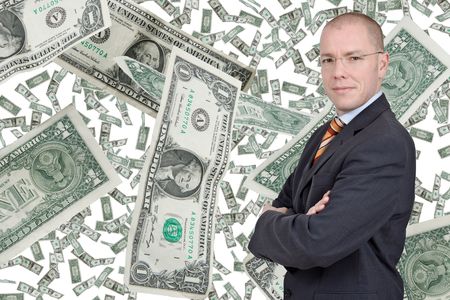 Young businessman with falling dollars in the backgriund.の写真素材