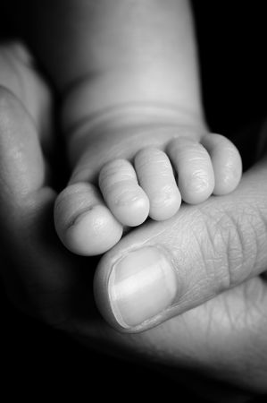 Foot from a four weeks old baby. Studio picture in black and whiteの写真素材