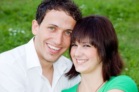 Young, happy and smiling couple in a park.の写真素材
