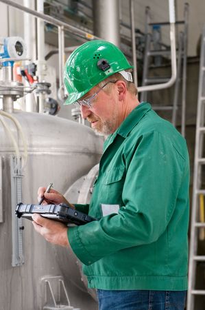 Middle aged industrial worker with notebook   