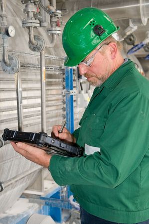 Middle aged industrial worker with notebook   