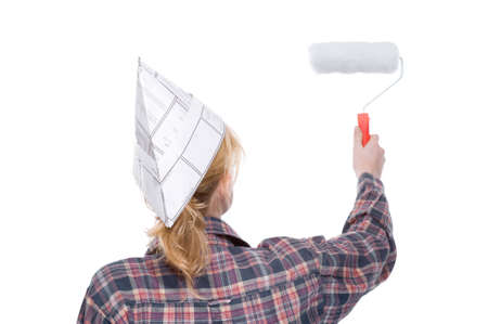 Full isolated studio picture from a young woman with a paint rollerの写真素材