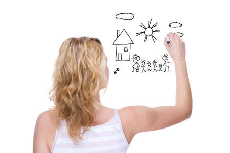 Full isolated portrait of a beautiful caucasian woman drawing a family pictureの写真素材
