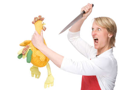 Full isolated studio picture from a young cook with knife and chickenの写真素材