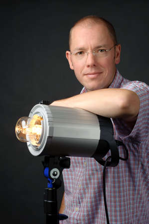 Full isolated studio picture from a young photographer with a studio flash unit
の写真素材