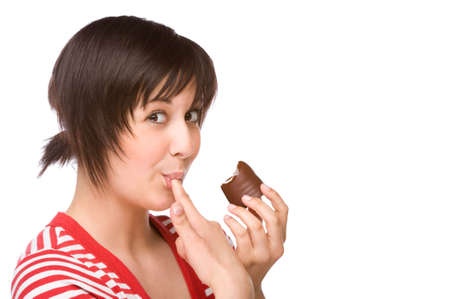 Full isolated portrait of a beautiful caucasian woman eating some sweetsの写真素材