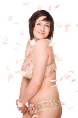 Full isolated studio picture from a young woman with falling flowersの写真素材