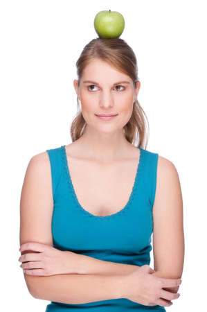 Full isolated studio picture from a young woman with an appleの写真素材