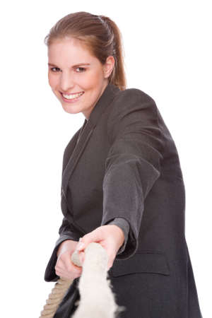 Full isolated studio picture from a young and beautiful business woman doing tug of warの写真素材
