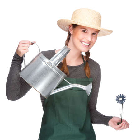 Full isolated portrait of a beautiful caucasian gardener with watering canの写真素材