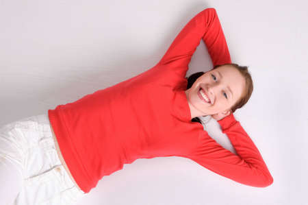 Young woman lying on the floorの写真素材