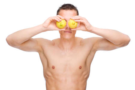 Full isolated studio picture from a young naked man with some fruitの写真素材