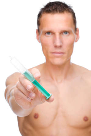 Full isolated studio picture from a young naked man with syringeの写真素材