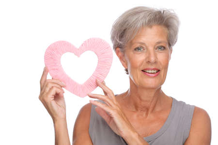 Full isolated portrait of a senior woman with heartの写真素材