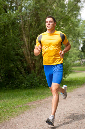 Young and smiling jogger  in the park